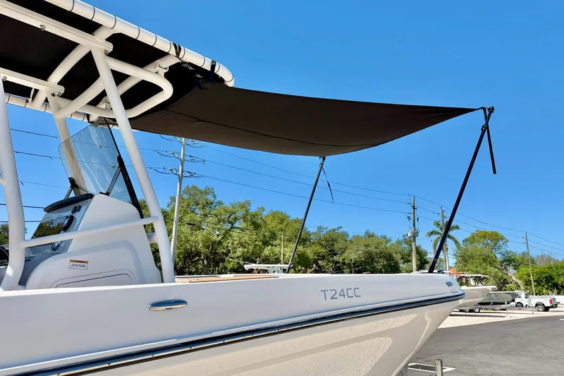 Slide: The Image of 2023 Bayliner Trophy T24CC boat with canopy under clear blue sky. - 38