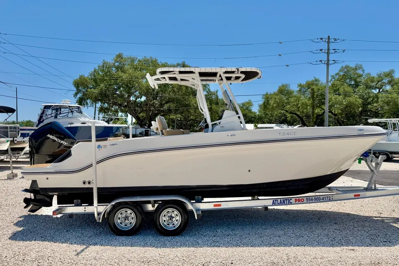 Slide: The Image of 2023 Bayliner Trophy T24CC boat on trailer, displayed outdoors. - 4
