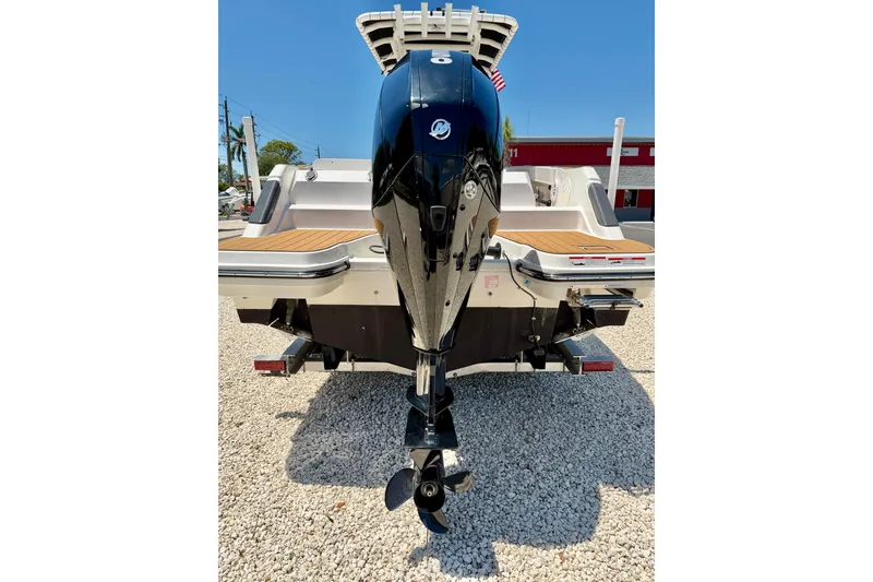 Slide: The Image of 2023 Bayliner Trophy T24CC boat with powerful outboard motor, displayed on gravel. - 40