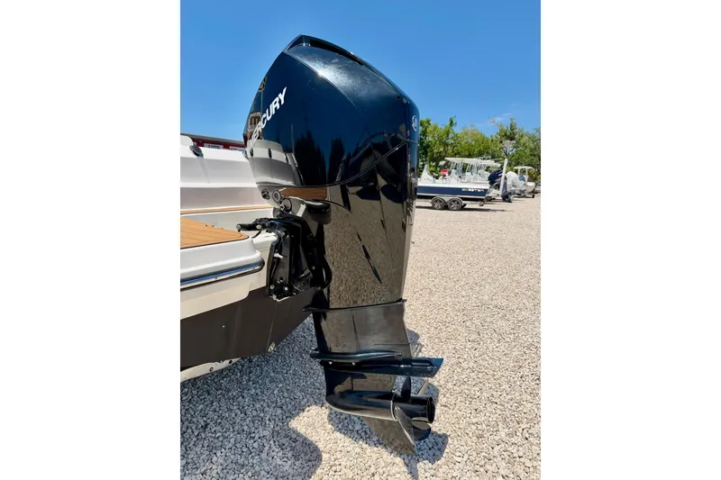 Slide: The Image of 2023 Bayliner Trophy T24CC boat with Mercury outboard motor on gravel lot. - 41