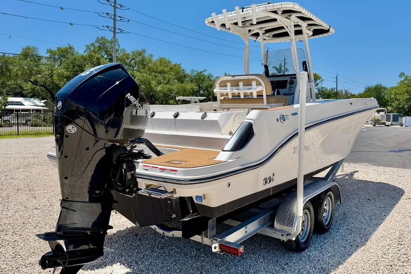Slide: The Image of 2023 Bayliner Trophy T24CC boat on trailer, featuring a powerful Mercury outboard motor. - 5