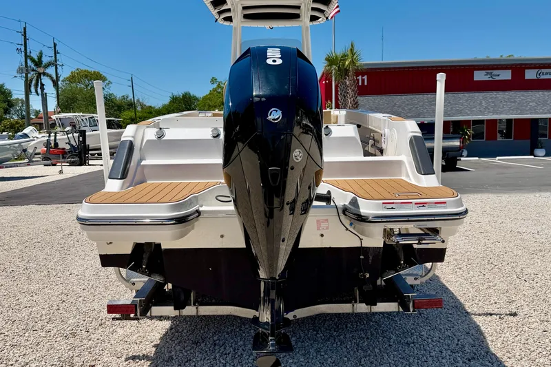 Slide: The Image of 2023 Bayliner Trophy T24CC boat with powerful outboard motor, displayed outdoors. - 6
