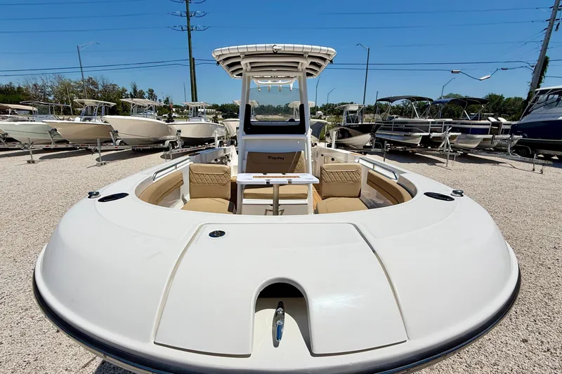 Slide: The Image of 2023 Bayliner Trophy T24CC boat with spacious seating, displayed outdoors on gravel lot. - 9
