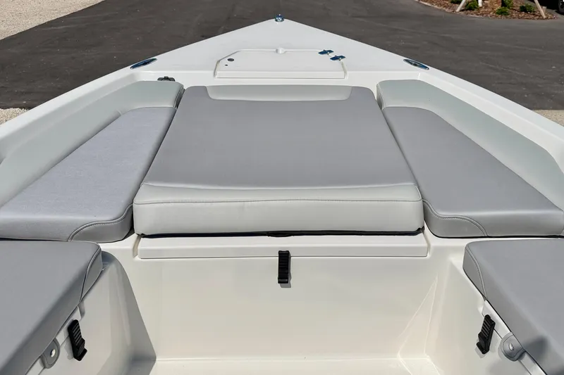 Slide: The Image of 2026 Bay Rider 239 Bay boat interior with cushioned seating and storage compartments. - 10