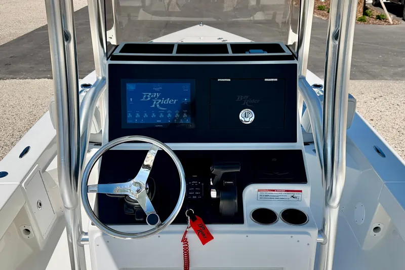 Slide: The Image of 2026 Bay Rider 239 Bay boat console with steering wheel and control panel. - 15