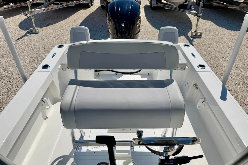 Slide: The Image of 2026 Bay Rider 239 Bay boat interior with dual seating and steering wheel. - 26