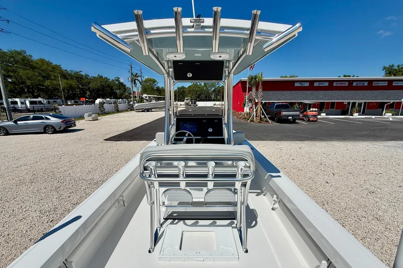 Slide: The Image of 2026 Bay Rider 239 Bay boat with T-top and console, parked in a dealership lot. - 28