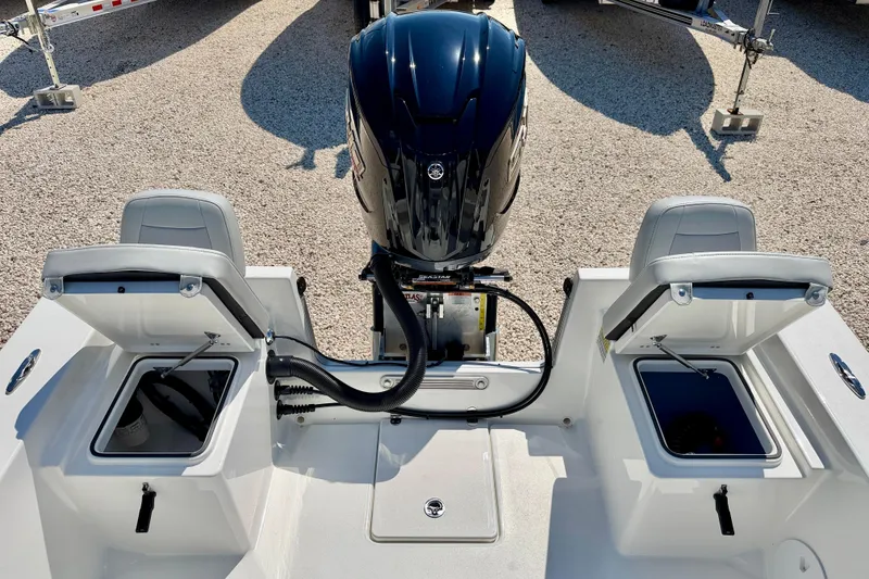 Slide: The Image of 2026 Bay Rider 239 Bay boat with open storage compartments and outboard motor. - 31