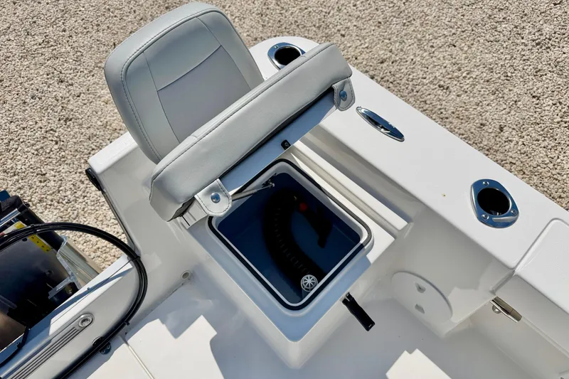 Slide: The Image of 2026 Bay Rider 239 Bay boat seat with storage compartment and cup holders. - 33
