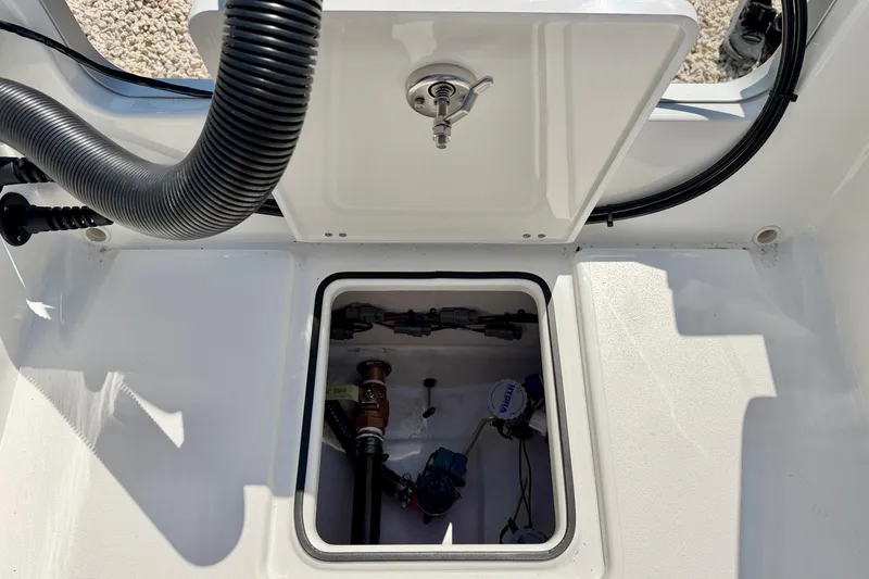 Slide: The Image of 2026 Bay Rider 239 Bay boat compartment with visible wiring and components. - 34