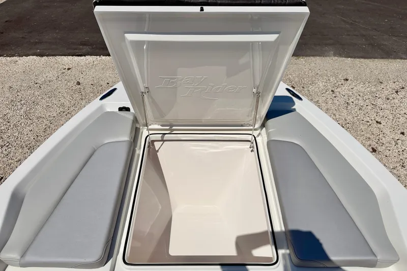 Slide: The Image of Open storage compartment on 2026 Bay Rider 239 Bay boat, featuring cushioned seating. - 36