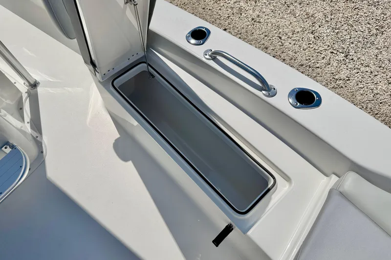 Slide: The Image of 2026 Bay Rider 239 Bay boat interior with storage compartment and rod holders. - 37