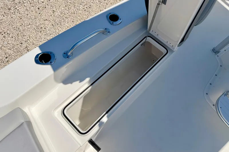 Slide: The Image of Open storage compartment on 2026 Bay Rider 239 Bay boat deck. - 38