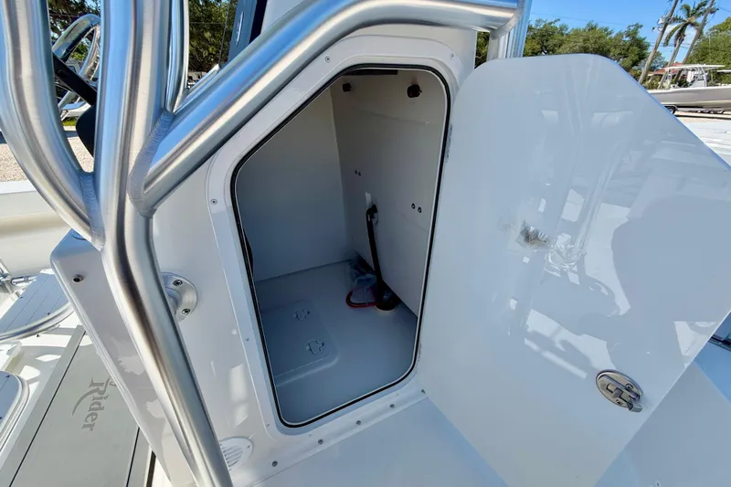 Slide: The Image of 2026 Bay Rider 239 Bay boat storage compartment with open door, showcasing interior space. - 42