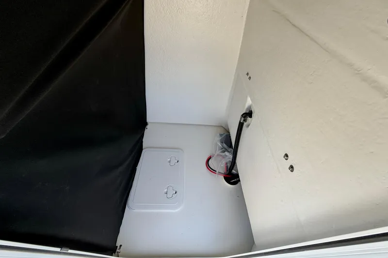 Slide: The Image of Interior compartment of 2026 Bay Rider 239 Bay boat, featuring storage and wiring. - 43