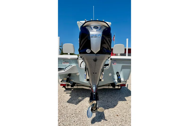 Slide: The Image of 2026 Bay Rider 239 Bay boat with powerful outboard motor, displayed on gravel surface. - 48
