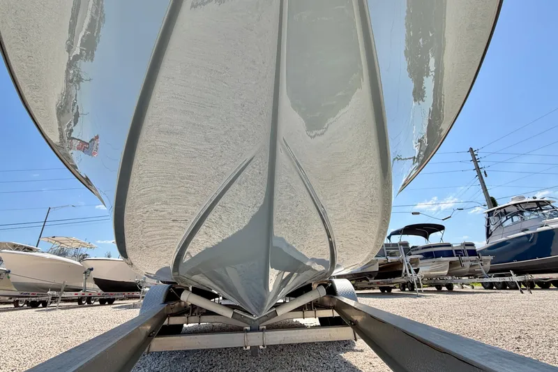 Slide: The Image of 2026 Bay Rider 239 Bay boat on trailer, viewed from below, in a sunny outdoor setting. - 49