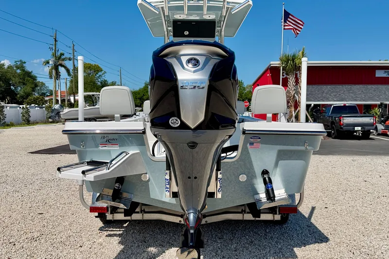 Slide: The Image of 2026 Bay Rider 239 Bay boat with powerful outboard motor, parked outdoors. - 6
