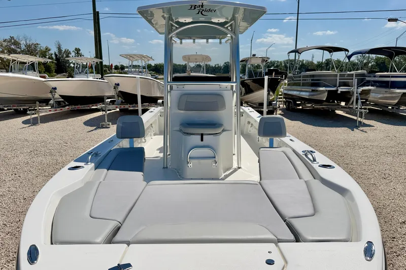 Slide: The Image of 2026 Bay Rider 239 Bay boat with spacious seating, displayed outdoors among other boats. - 8