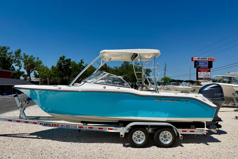 The Image of 2024 Key West 239 DFS boat on trailer, vibrant blue hull, sunny day. - 0
