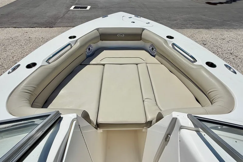 Slide: The Image of 2024 Key West 239 DFS boat interior with beige cushioned seating. - 10
