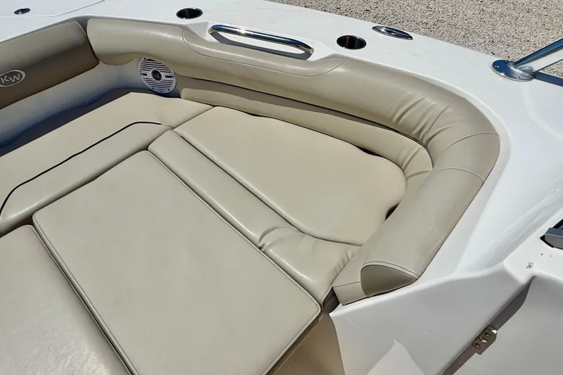 Slide: The Image of 2024 Key West 239 DFS boat interior with beige cushioned seating and speaker. - 11