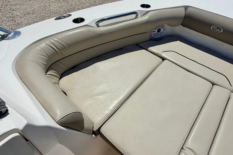 Slide: The Image of 2024 Key West 239 DFS boat with beige cushioned seating and speaker detail. - 12