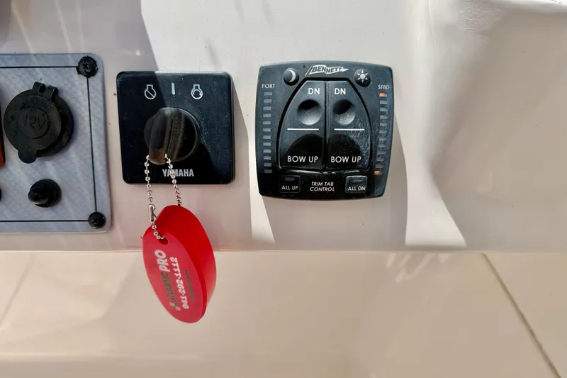 Slide: The Image of Control panel of a 2024 Key West 239 DFS boat with Yamaha ignition and trim tab controls. - 17