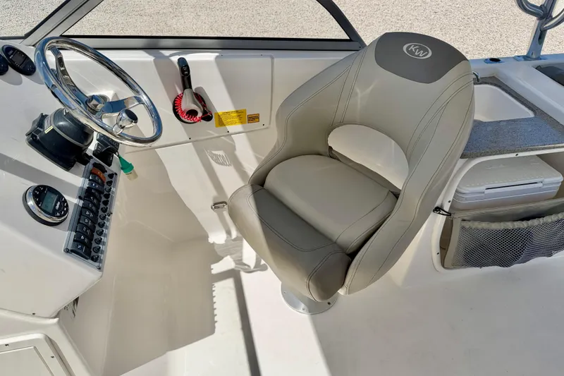 Slide: The Image of 2024 Key West 239 DFS boat cockpit with steering wheel and comfortable seating. - 19