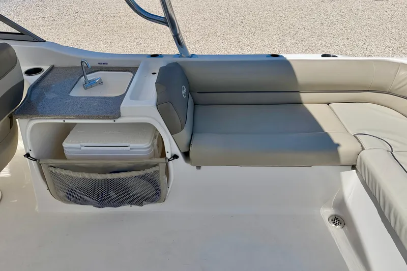 Slide: The Image of 2024 Key West 239 DFS boat interior with sink, seating, and storage area. - 25
