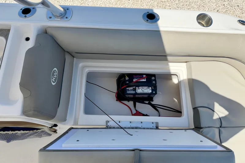 Slide: The Image of 2024 Key West 239 DFS boat battery compartment with wiring and storage area. - 27