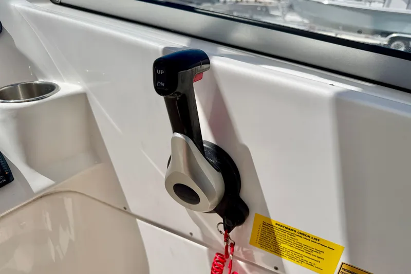 Slide: The Image of Throttle control lever on a 2024 Key West 239 DFS boat dashboard. - 29