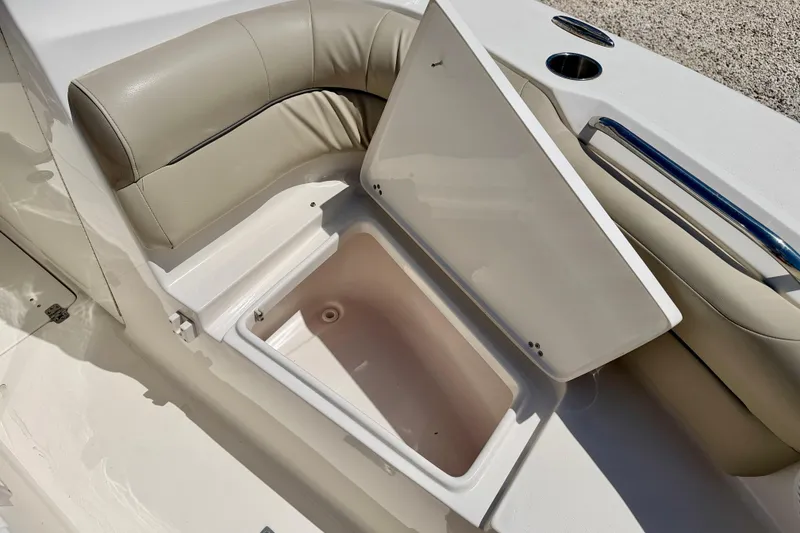 Slide: The Image of Open storage compartment on 2024 Key West 239 DFS boat with beige seating. - 34