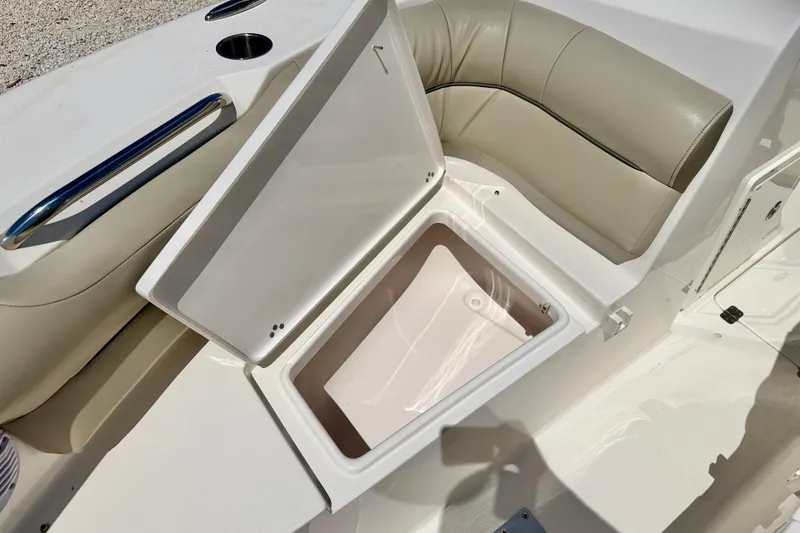 Slide: The Image of Open storage compartment on 2024 Key West 239 DFS boat with beige seating. - 35
