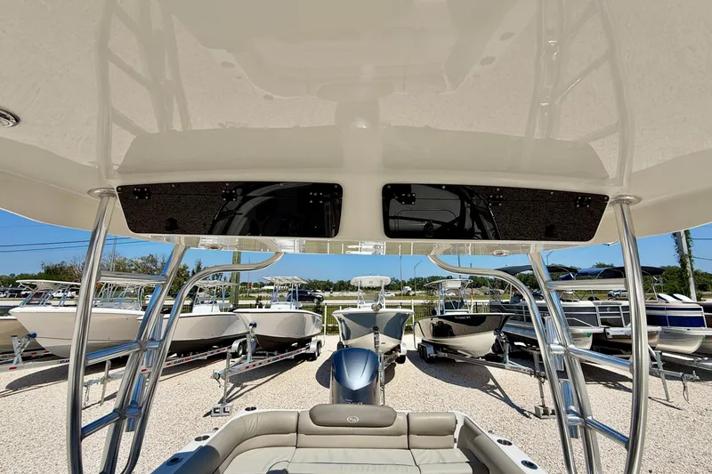 Slide: The Image of 2024 Key West 239 DFS boat interior with seating and overhead view at a dealership. - 36