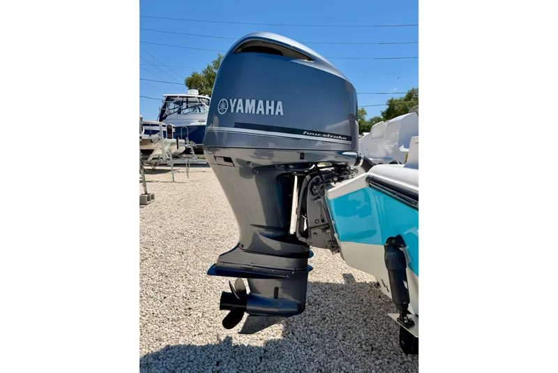 Slide: The Image of 2024 Key West 239 DFS boat with Yamaha outboard motor in a sunny outdoor setting. - 39