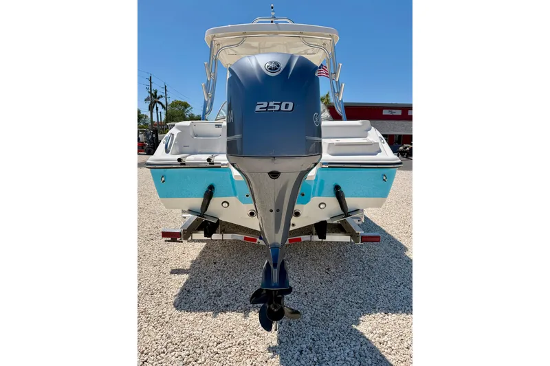 Slide: The Image of 2024 Key West 239 DFS boat with Yamaha 250 engine, parked on gravel. - 40