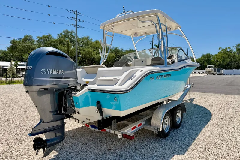 Slide: The Image of 2024 Key West 239 DFS boat with Yamaha engine on trailer, parked outdoors. - 5