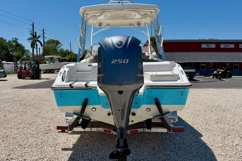 Slide: The Image of 2024 Key West 239 DFS boat with Yamaha 250 engine, parked on gravel. - 6