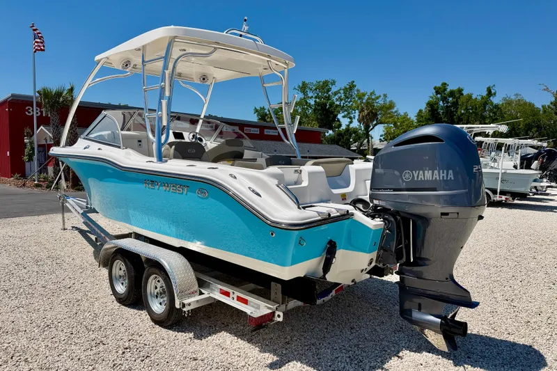 Slide: The Image of 2024 Key West 239 DFS boat with Yamaha engine on trailer, displayed outdoors. - 7