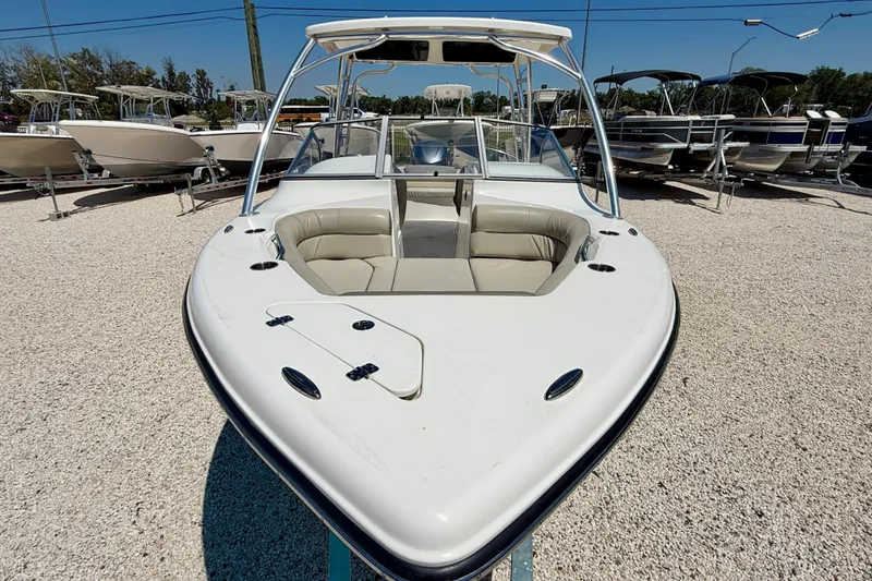Slide: The Image of 2024 Key West 239 DFS boat with spacious seating, displayed outdoors on gravel. - 8