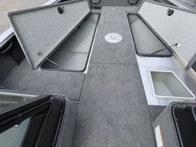 Slide: The Image of Interior of 2026 Lund 2075 Impact XS Sport with storage compartments. - 13