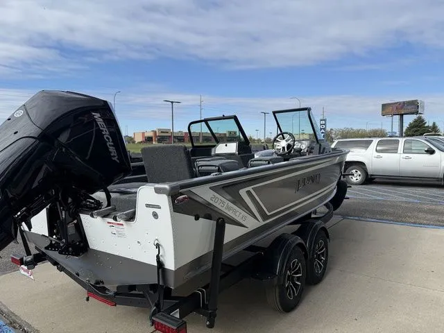 Slide: The Image of 2026 Lund 2075 Impact XS Sport boat on trailer outdoors. - 7