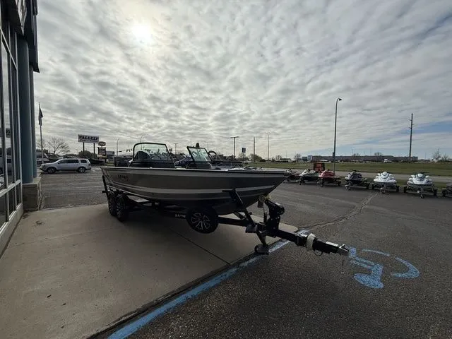 Slide: The Image of 2026 Lund 2075 Impact XS Sport boat on trailer outdoors. - 8