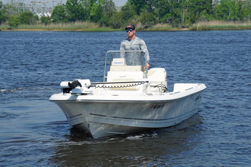 The Image of Man piloting a 2020 Bulls Bay 2000 boat on a calm lake. - 0