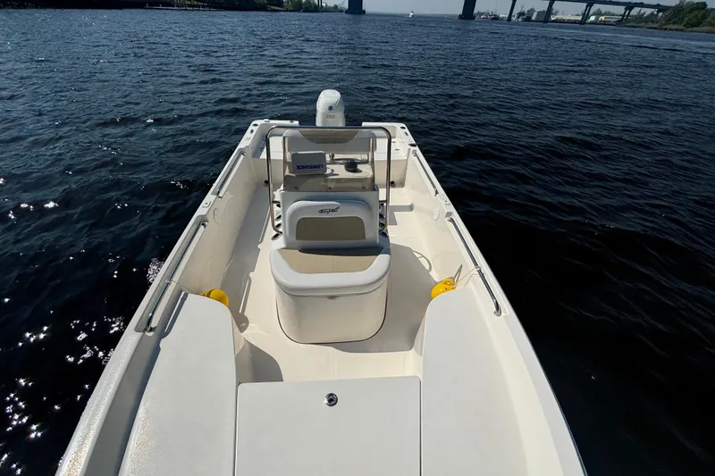 Slide: The Image of 2020 Bulls Bay 2000 boat on calm water, featuring spacious deck and seating. - 5