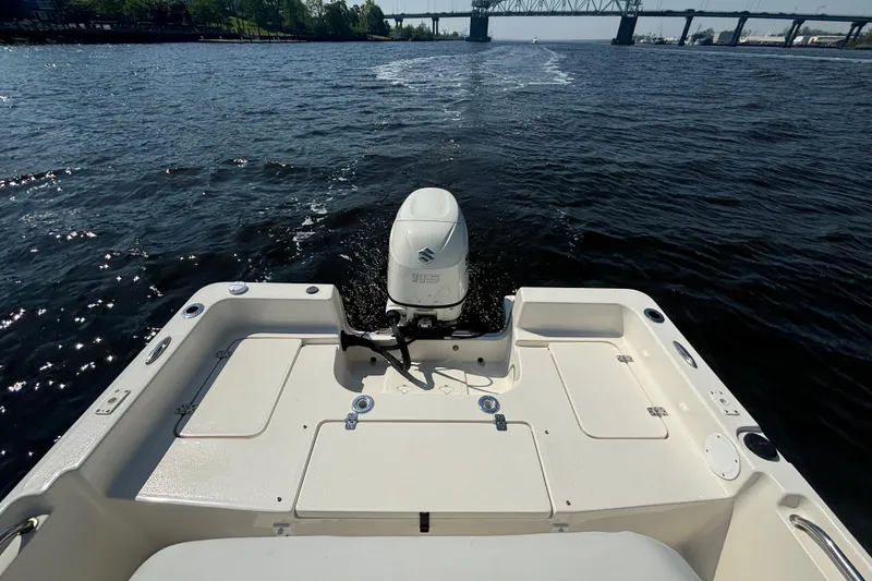 Slide: The Image of 2020 Bulls Bay 2000 boat cruising on a river with a bridge in the background. - 9