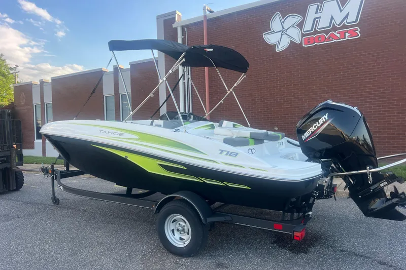 Slide: The Image of 2023 Tahoe T18 boat with Mercury engine on trailer outside HM Boats building. - 12