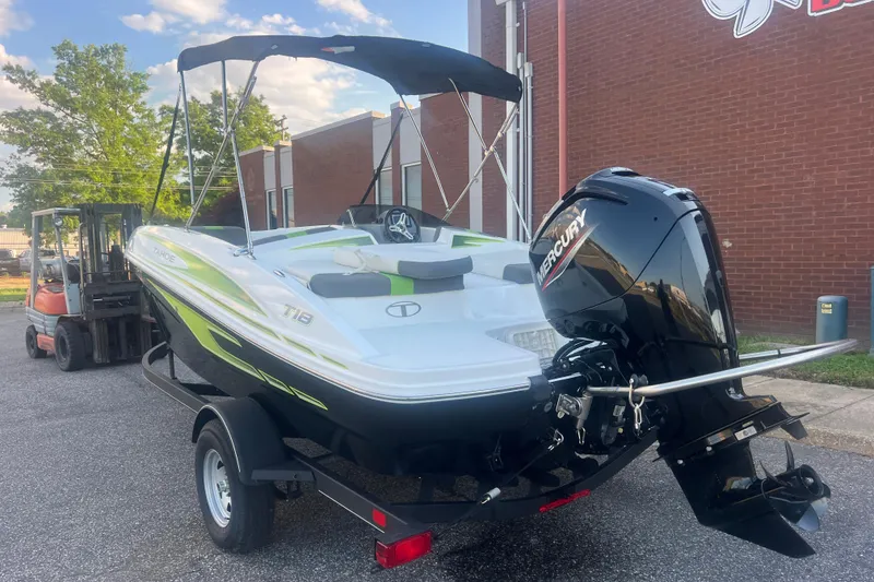 Slide: The Image of 2023 Tahoe T18 boat with Mercury engine on trailer, parked outdoors. - 13