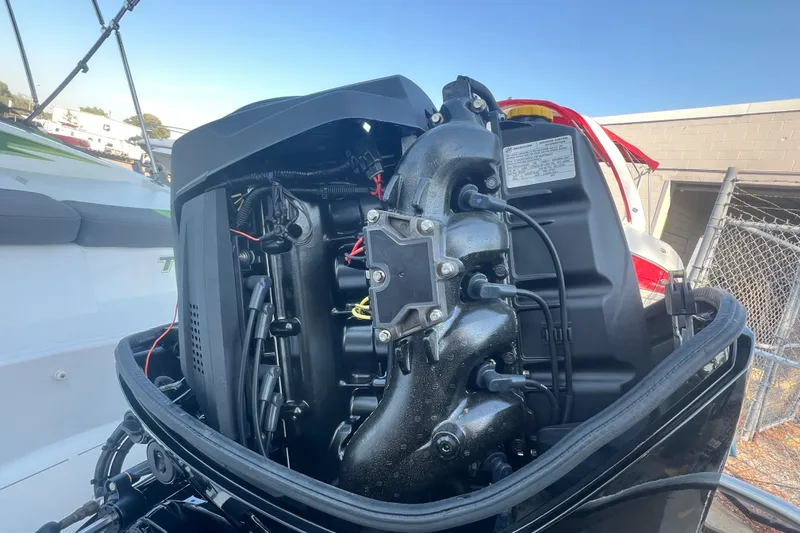 Slide: The Image of 2023 Tahoe T18 boat engine close-up, showcasing intricate mechanical components. - 14